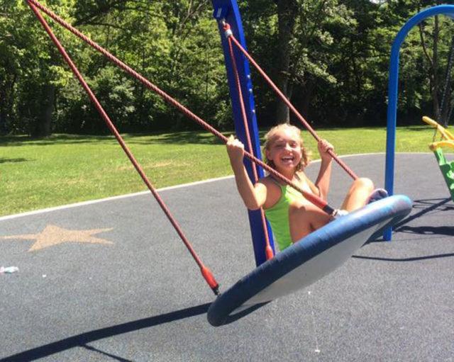 girl on swing smiling
