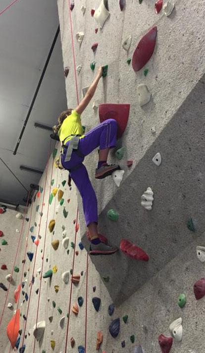 girl climbing on climbing wall