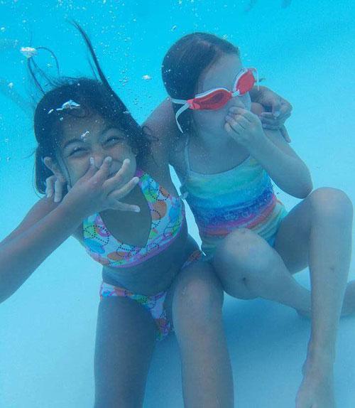 two girls underwater in pool